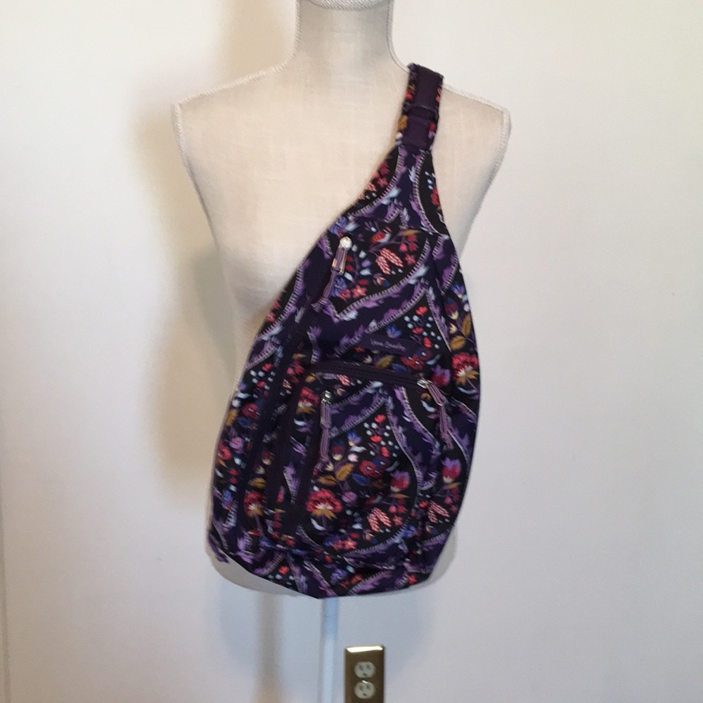 Vera Bradley sling backpack in purple floral pattern